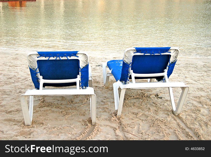 Beach blue chairs in a  cancun beach