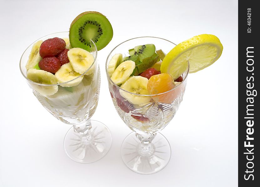 Fruits salad in the cups on white