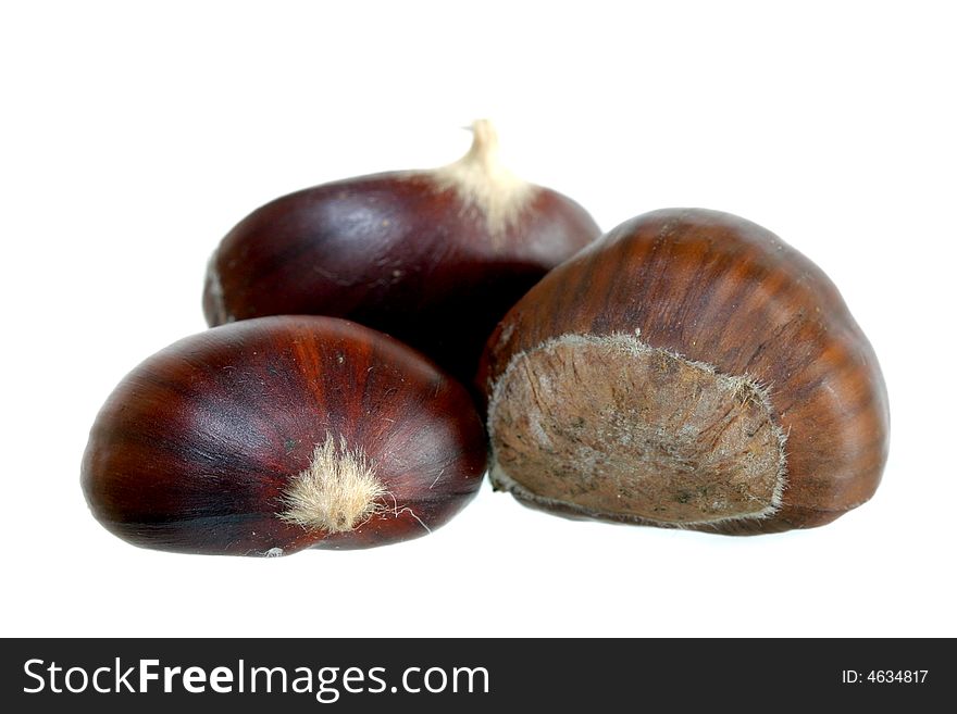 Three chestnuts on white background