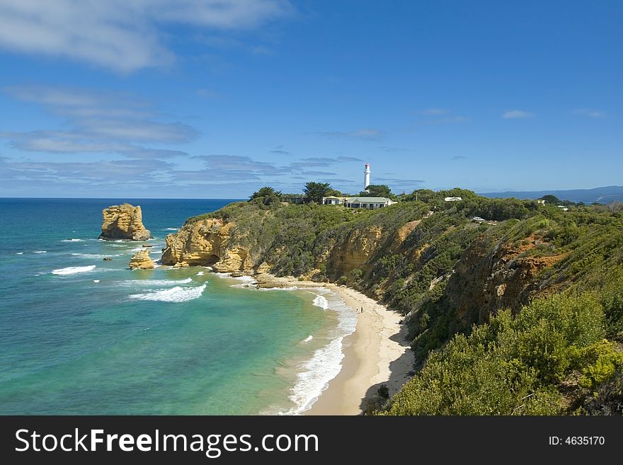 Coastal australian landscape with lighthouse and single rock. Coastal australian landscape with lighthouse and single rock