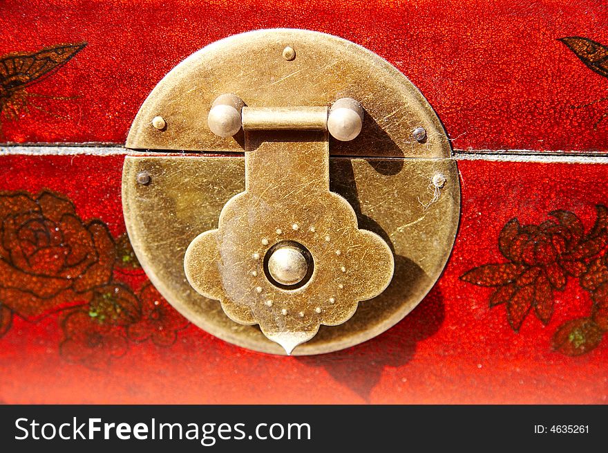 Detail of chinese furniture,round lock on red wooden furniture. Detail of chinese furniture,round lock on red wooden furniture