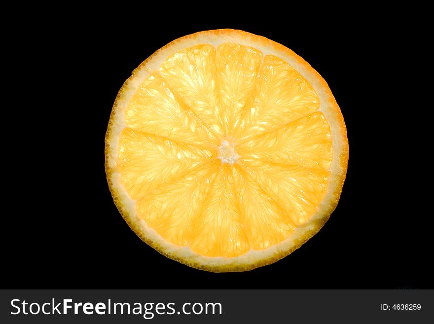 Slice of orange isolated on a black background