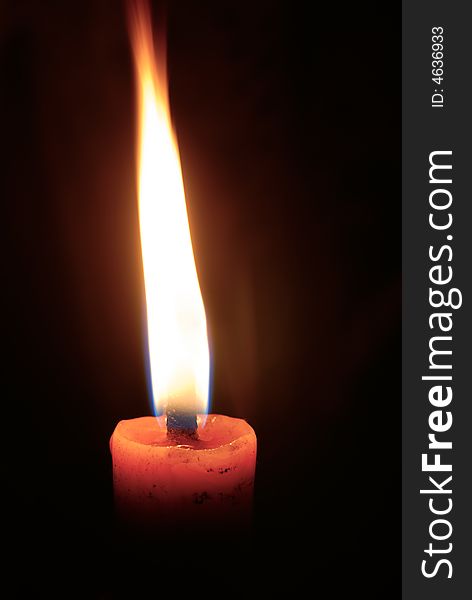 Burning candle with balck background