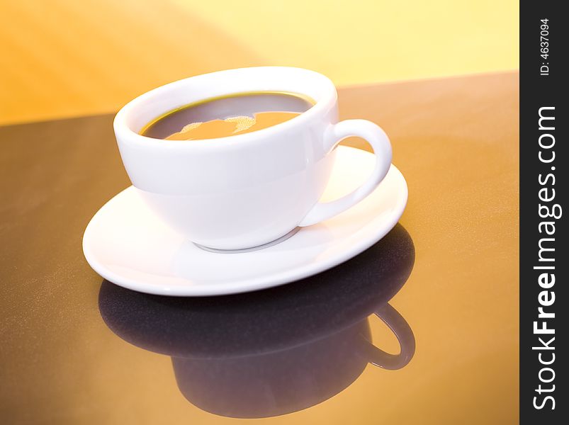 Cup of coffee on the gold background / sunshine