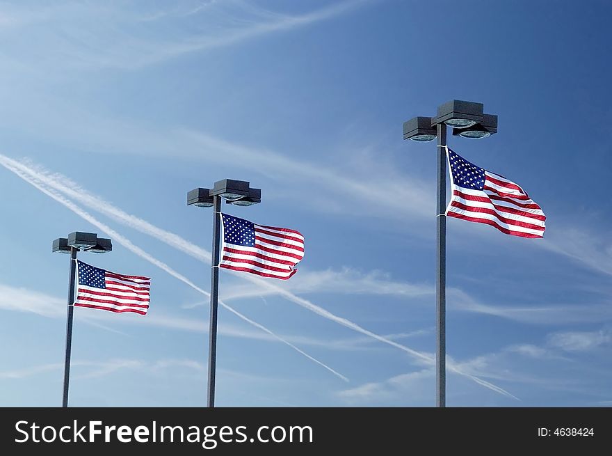 A picture of three flags taken shortly after 911 with military jets in the sky