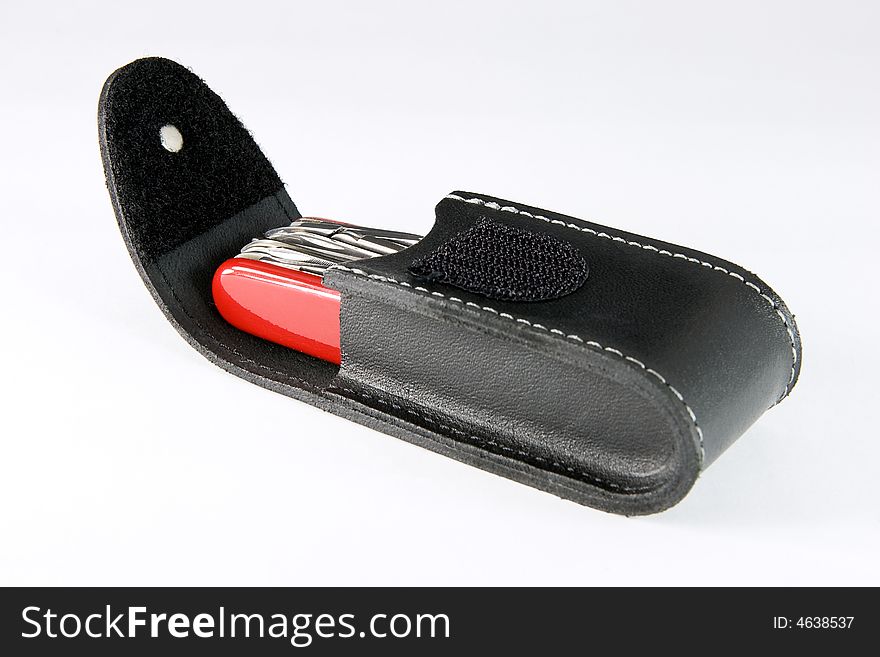 Multifunctional pocket knife in leather pouch on white background