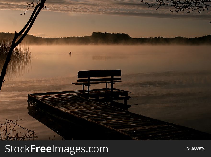 Bench on a pier in a cold morning