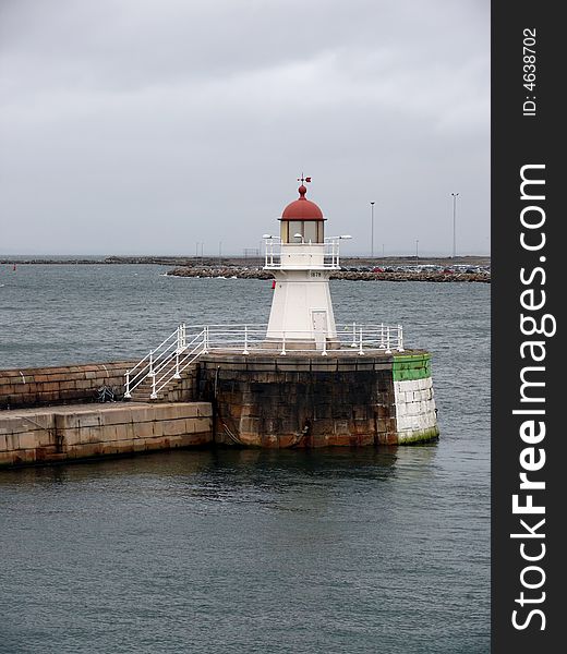 Portrait of an old lighthouse on gray sky