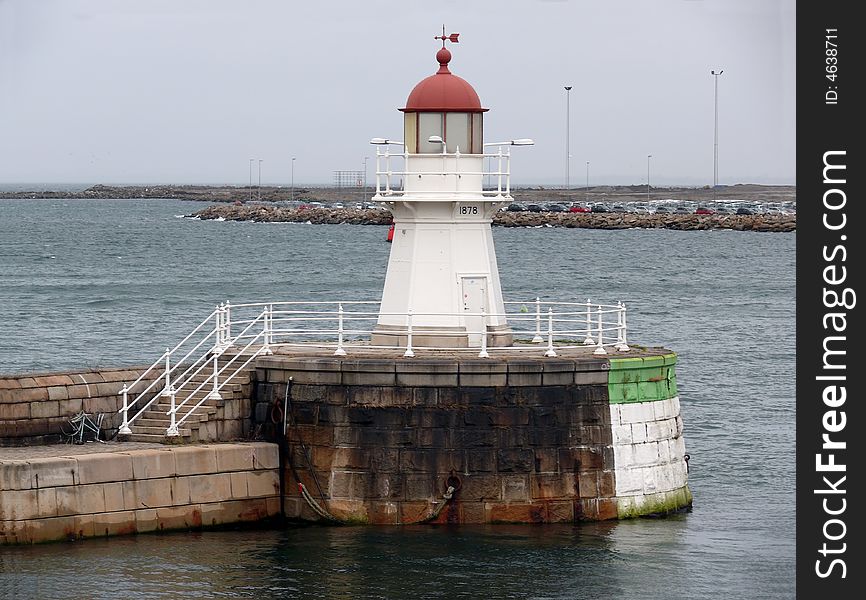 Portrait of an old lighthouse on gray sky