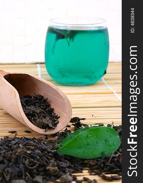 Dry leaves of green tea on white background