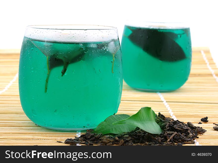 Dry leaves of green tea on white background