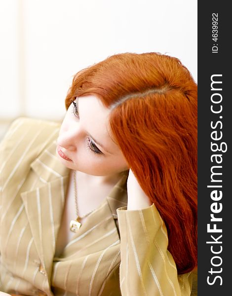 Melancholic redhead woman in classical suit sit down in office