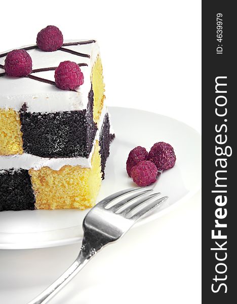 Checkerboard Cake with Raspberries on a white background.
