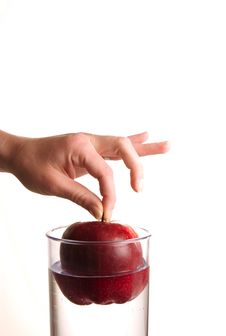 Human Hand Holding Apple Over Water Royalty Free Stock Image