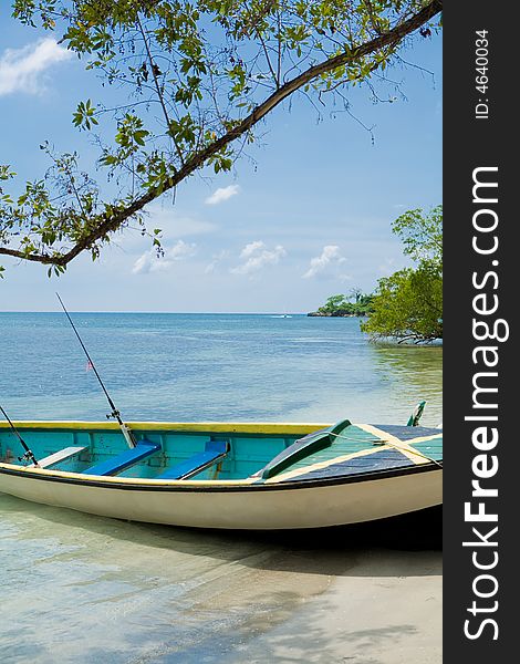 Boat on the shore of a tropical beach. Boat on the shore of a tropical beach