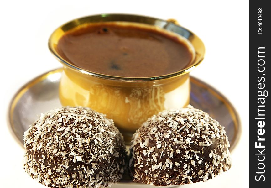 Cup of coffee and sweet with a coco on a white background