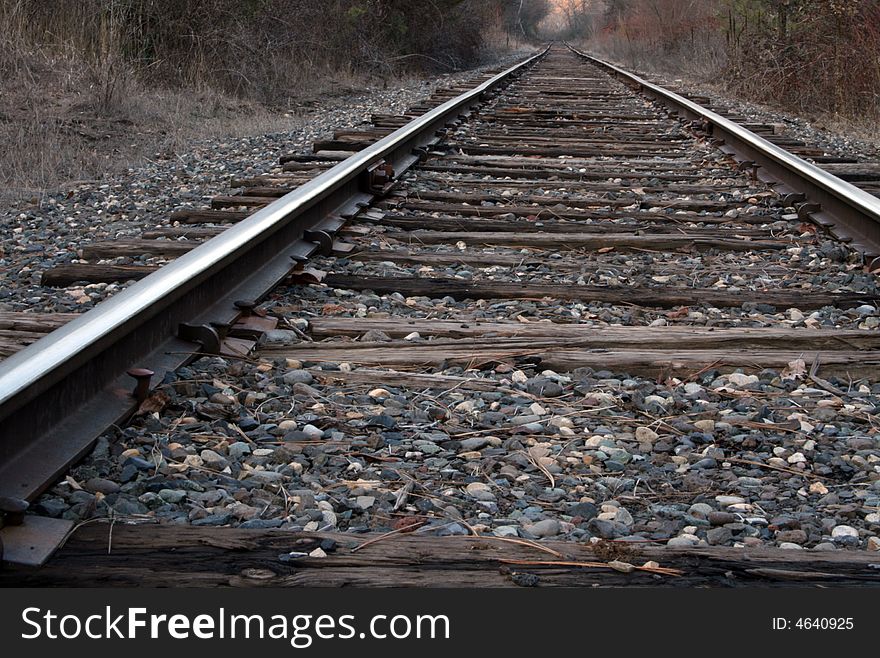 A set of railroad tracks trailing off into the distance.