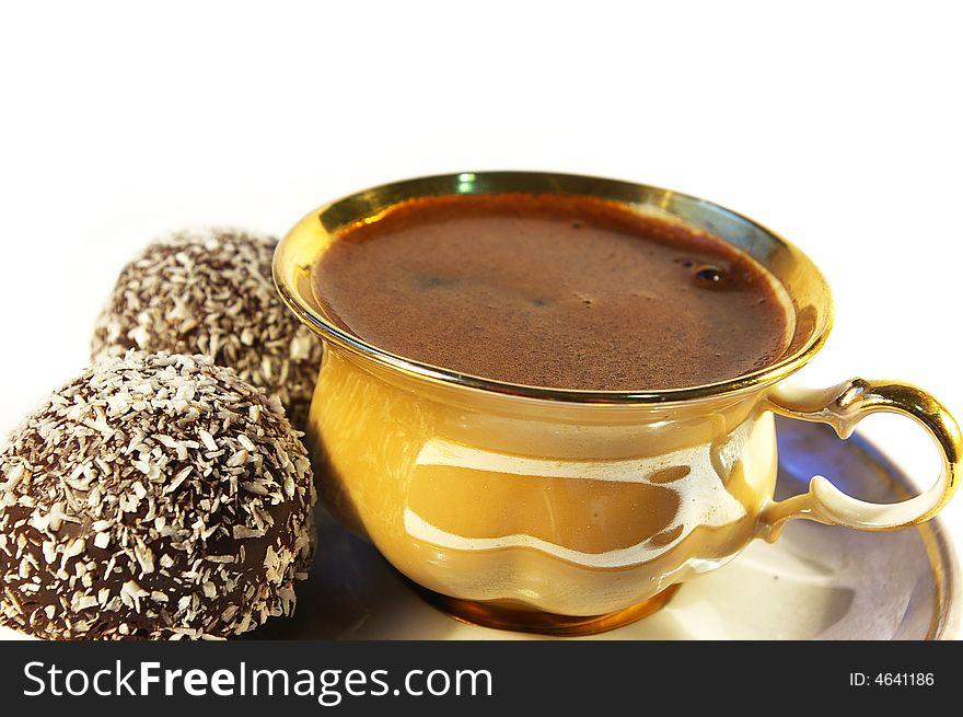 Cup of coffee and sweet with a coco on a white background