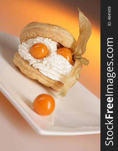 Cream dessert with exotic fruit on white plate. Cream dessert with exotic fruit on white plate