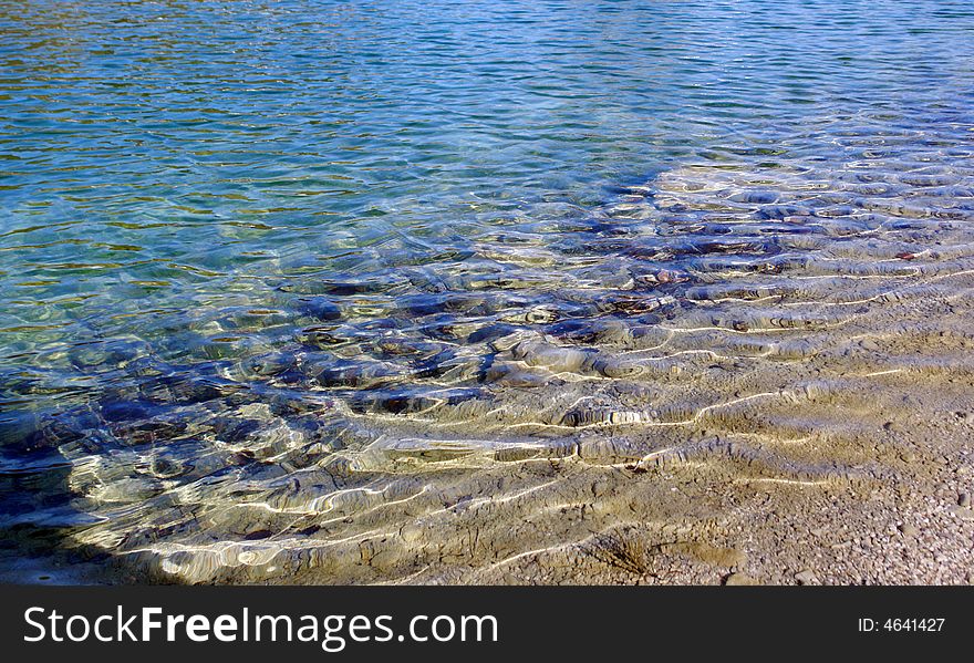 Ripples on the water at the shoreline of the Small Zellersee .Chimgauer Alpes Germany Bavaria. Ripples on the water at the shoreline of the Small Zellersee .Chimgauer Alpes Germany Bavaria