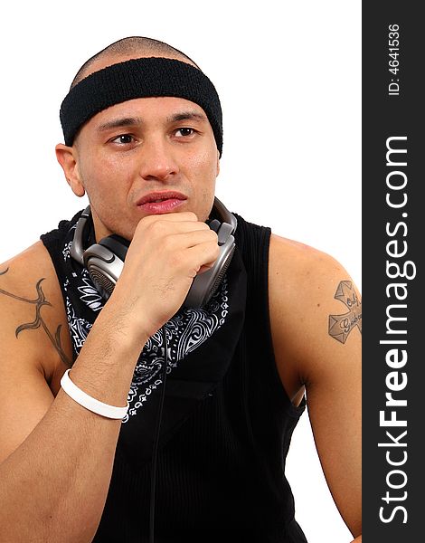 A young DJ with headphones in black with a tattoo. A young DJ with headphones in black with a tattoo.