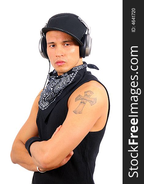A young DJ with headphones in black with tattoo. A young DJ with headphones in black with tattoo.