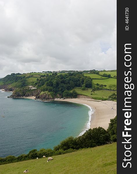 Beautiful cove in devon britain on cloudy day, calm sea and clean sand. Beautiful cove in devon britain on cloudy day, calm sea and clean sand