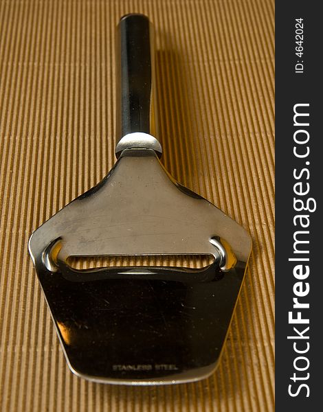 Wire Cheese Slicer against a Rustic background. Wire Cheese Slicer against a Rustic background
