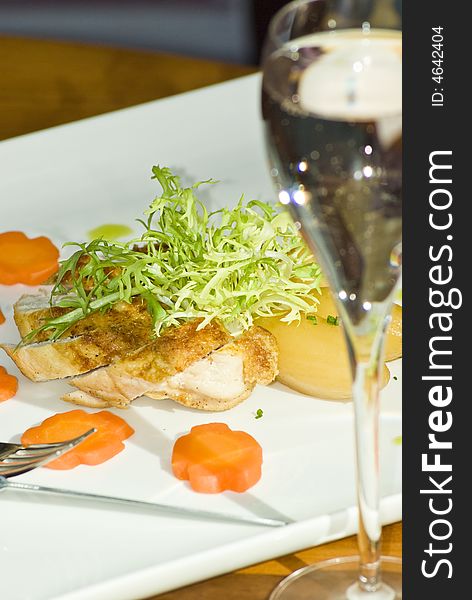 Healthy lunch dish in modern british restaurant, with clean white crockery, champagne and glasses. Healthy lunch dish in modern british restaurant, with clean white crockery, champagne and glasses