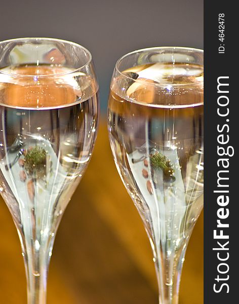 Lunch time dishes reflected in wine glasses in modern restaurant. Lunch time dishes reflected in wine glasses in modern restaurant