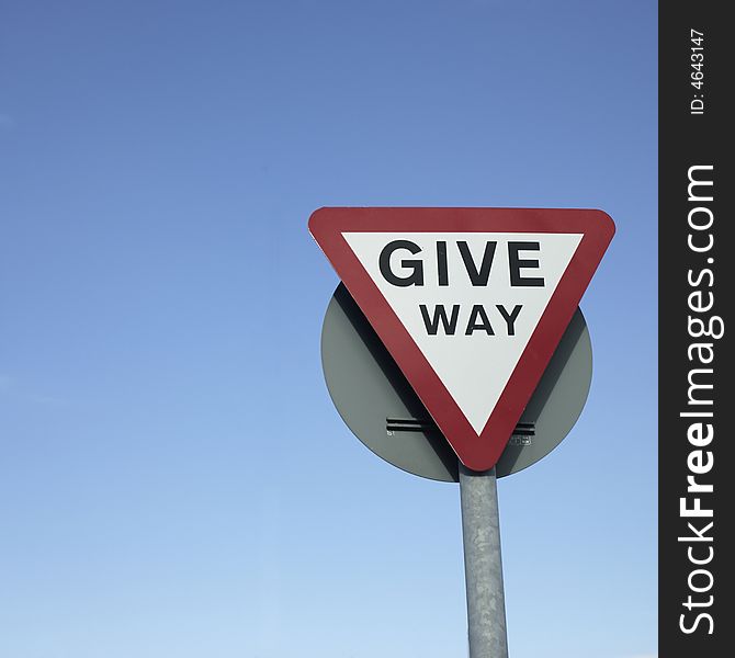 Give way sign with blue background sky