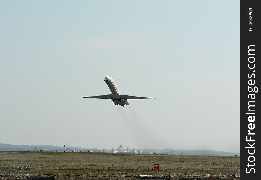 Commercial jet in flight taking off from a runway at Reagan National Airport in Washington, D.C. Commercial jet in flight taking off from a runway at Reagan National Airport in Washington, D.C.