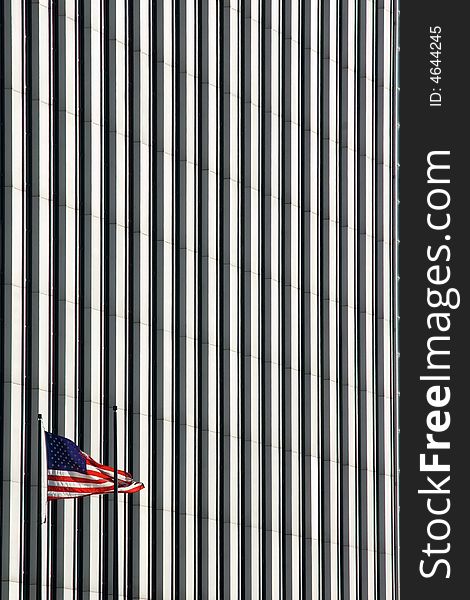 American flag interposed over the wall of a modern high-rise building. The stripes on the flag are repeated in the stripe-like texture of the building. American flag interposed over the wall of a modern high-rise building. The stripes on the flag are repeated in the stripe-like texture of the building.