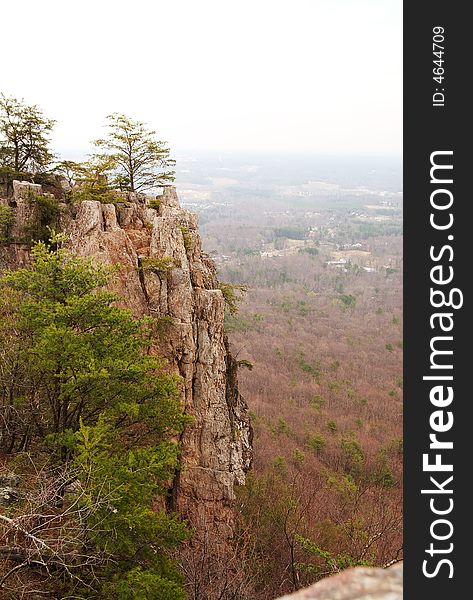 A scenic view of a cliffside overlooking some houses below. A scenic view of a cliffside overlooking some houses below.