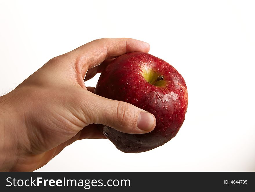 Hand holding apple on white background
