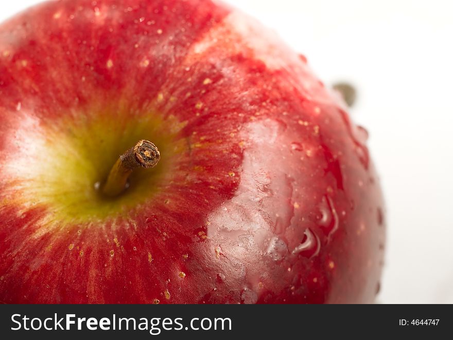 Close up red apple and stem on white isolated background.