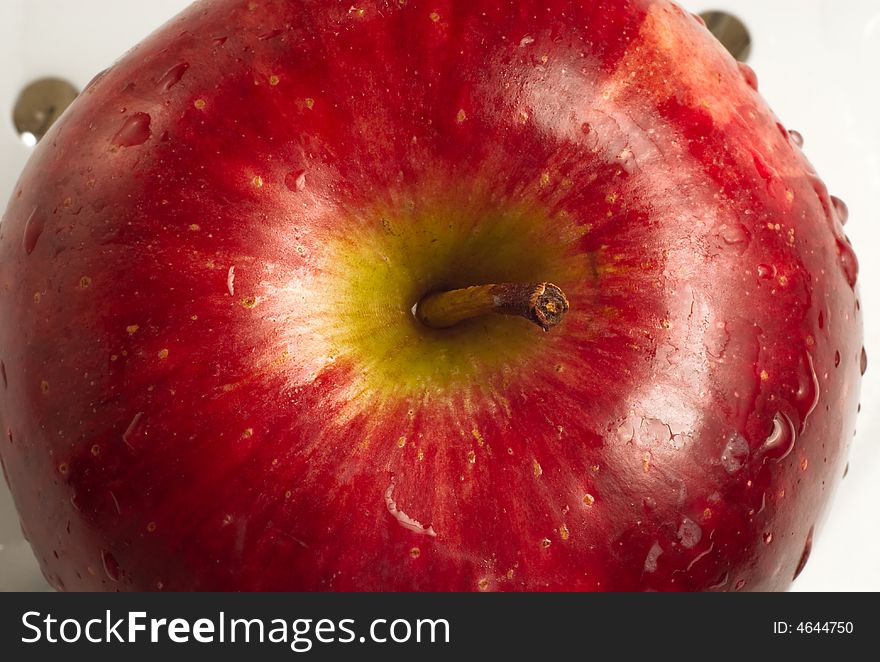 Close up red apple and stem on white isolated background.