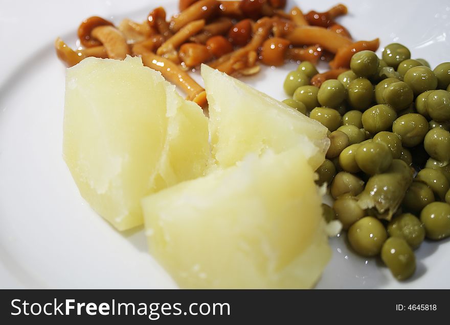 Close-up of vegetables garnish with boiled potatoes and marinaded mushrooms