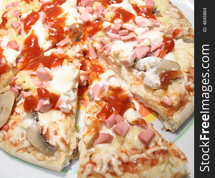 Fresh pizza with mushrooms and sausages on white plate. Fresh pizza with mushrooms and sausages on white plate