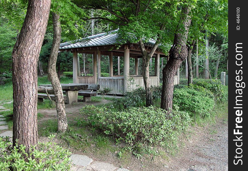 Traditional wooden resting place in a summer Japanese garden