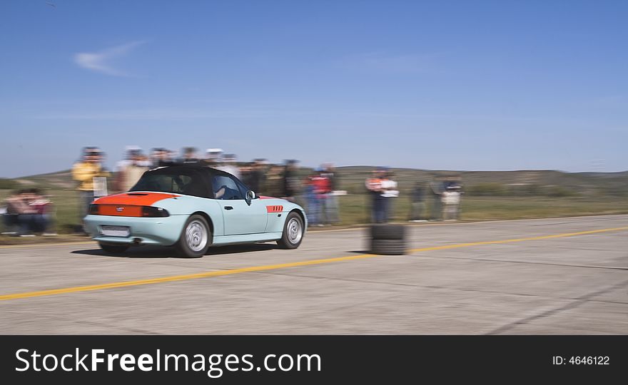 Panning image of a trendy car during a legal street car race.