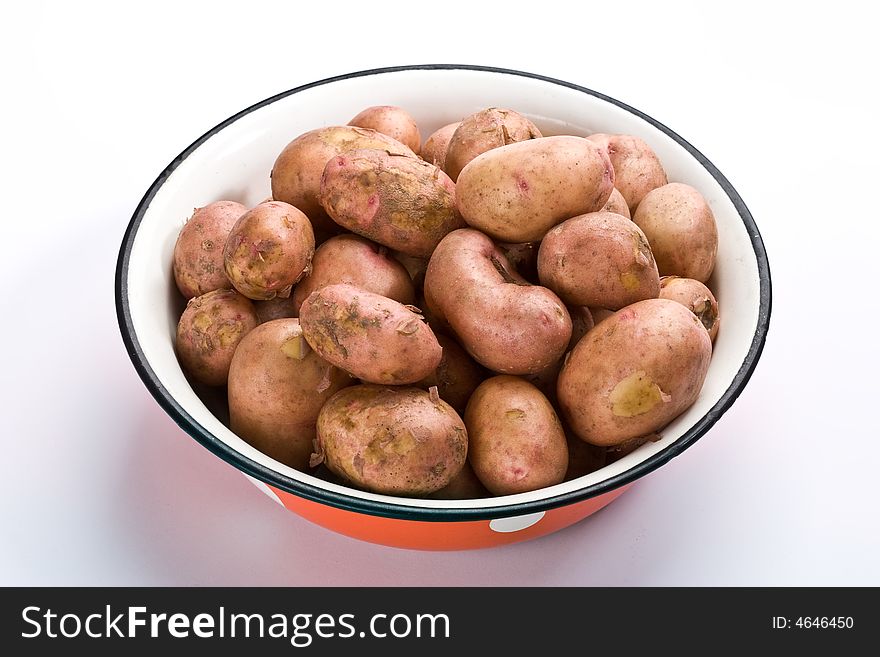 Hill of new potatoes on the basin