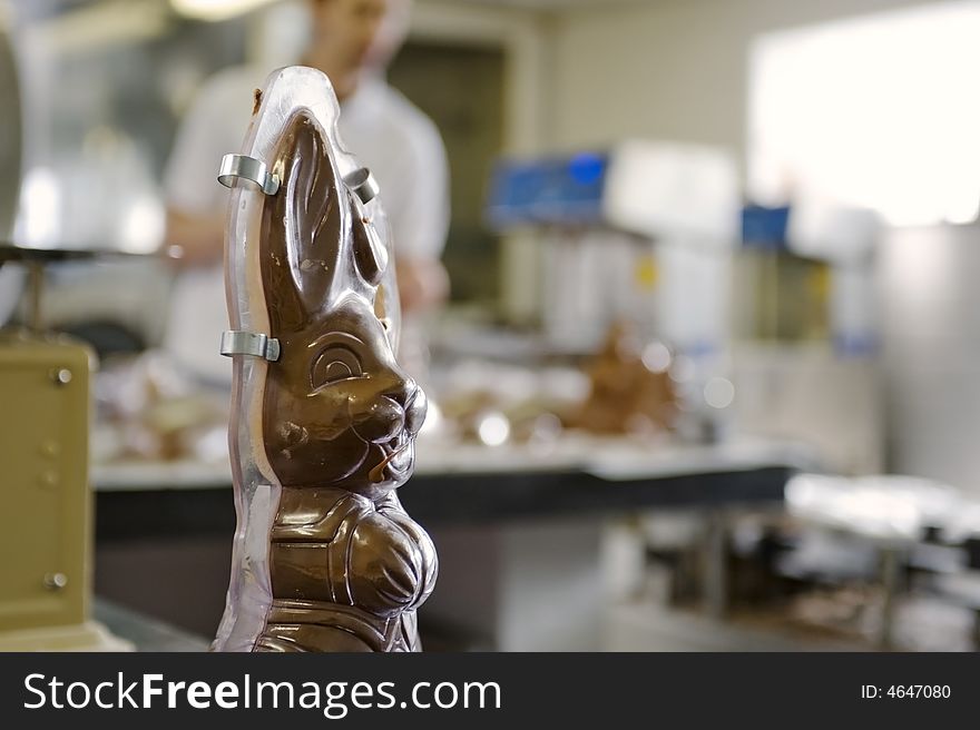 Making chocolate bunny in a bakery. close-up of bunny in plastic case.