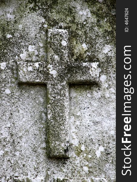 Close up of a cross carved onto a gravestone. Close up of a cross carved onto a gravestone