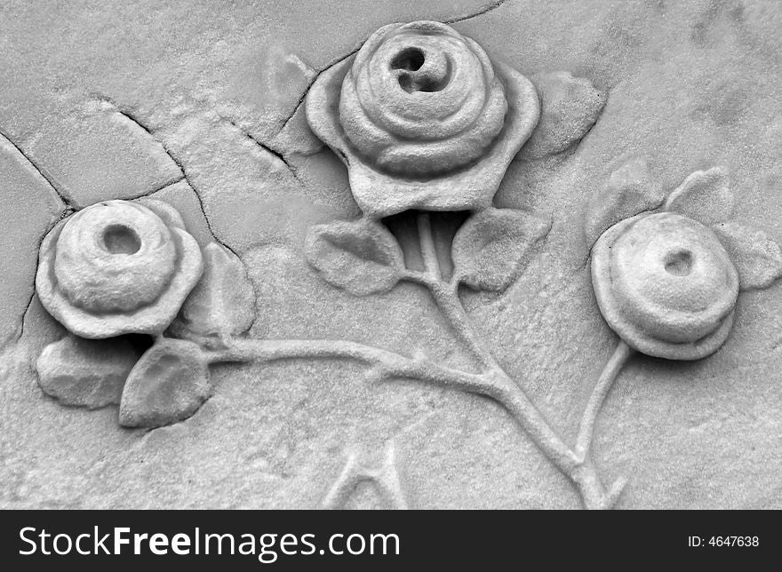 Roses carved into a gravestone in black and white. Roses carved into a gravestone in black and white