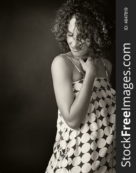 Portrait of a woman looking down in a studio on a black background