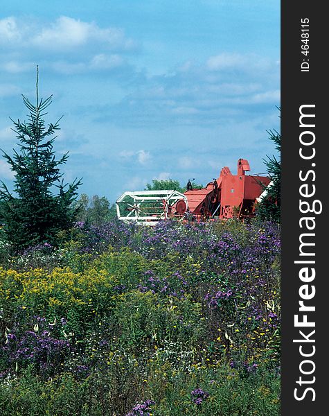 A thresher plowing through a field. A thresher plowing through a field