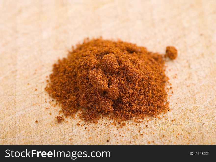 Pile of spice grains on a wooden board. Pile of spice grains on a wooden board
