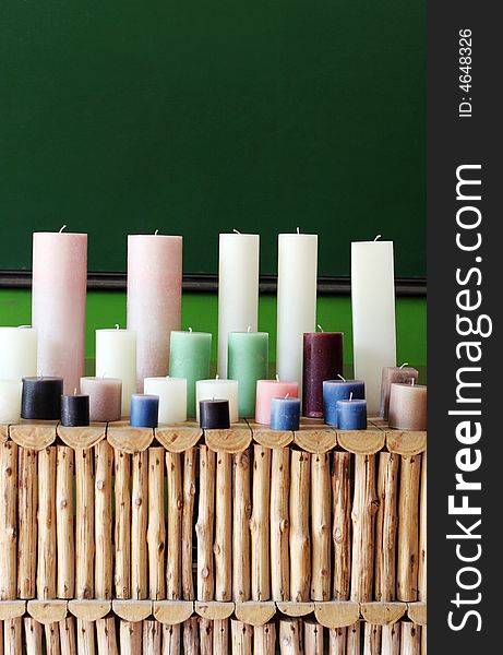 Rows of colorful wax candles on a shelf.