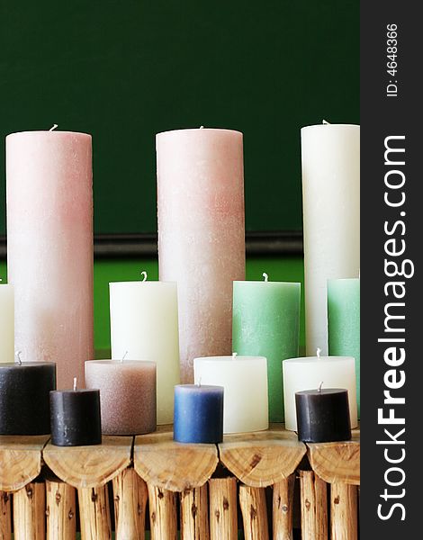 Rows of colorful wax candles on a shelf.
